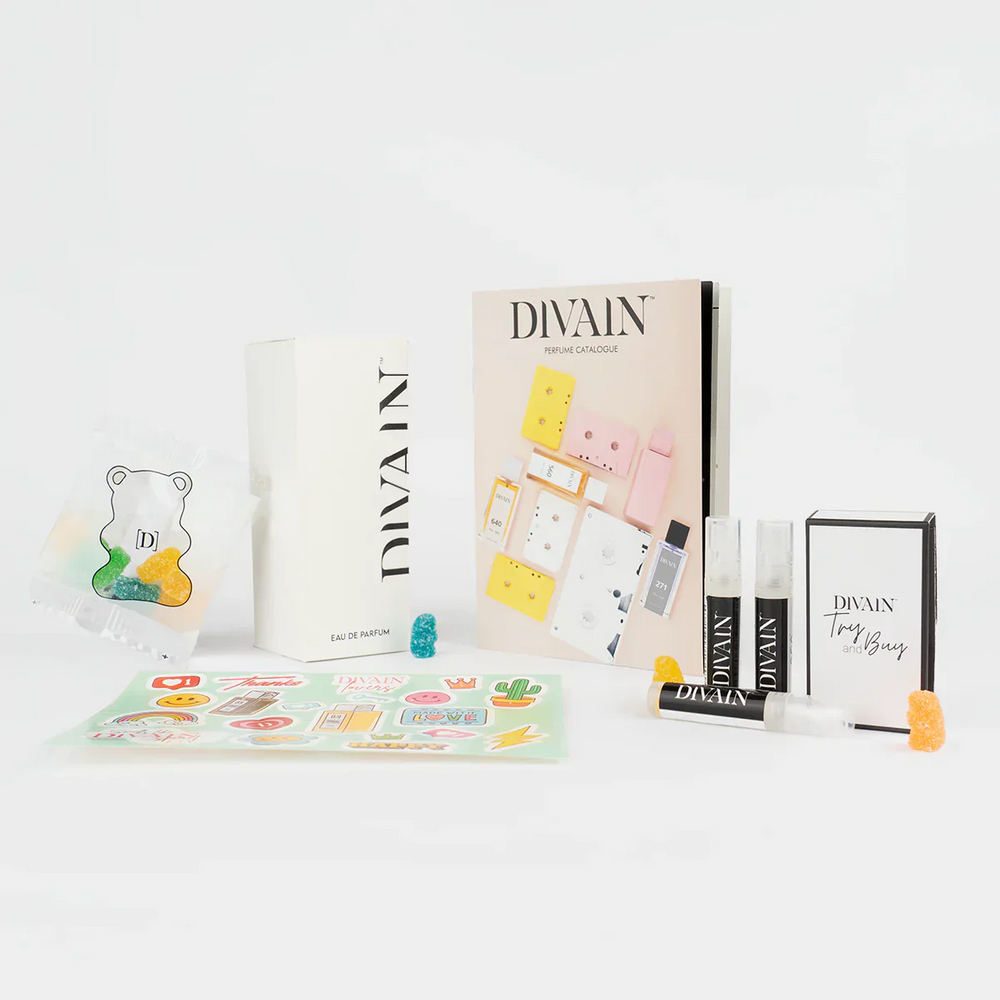 Opened divain package containing divain-174 perfume, stickers, and gummy candies
