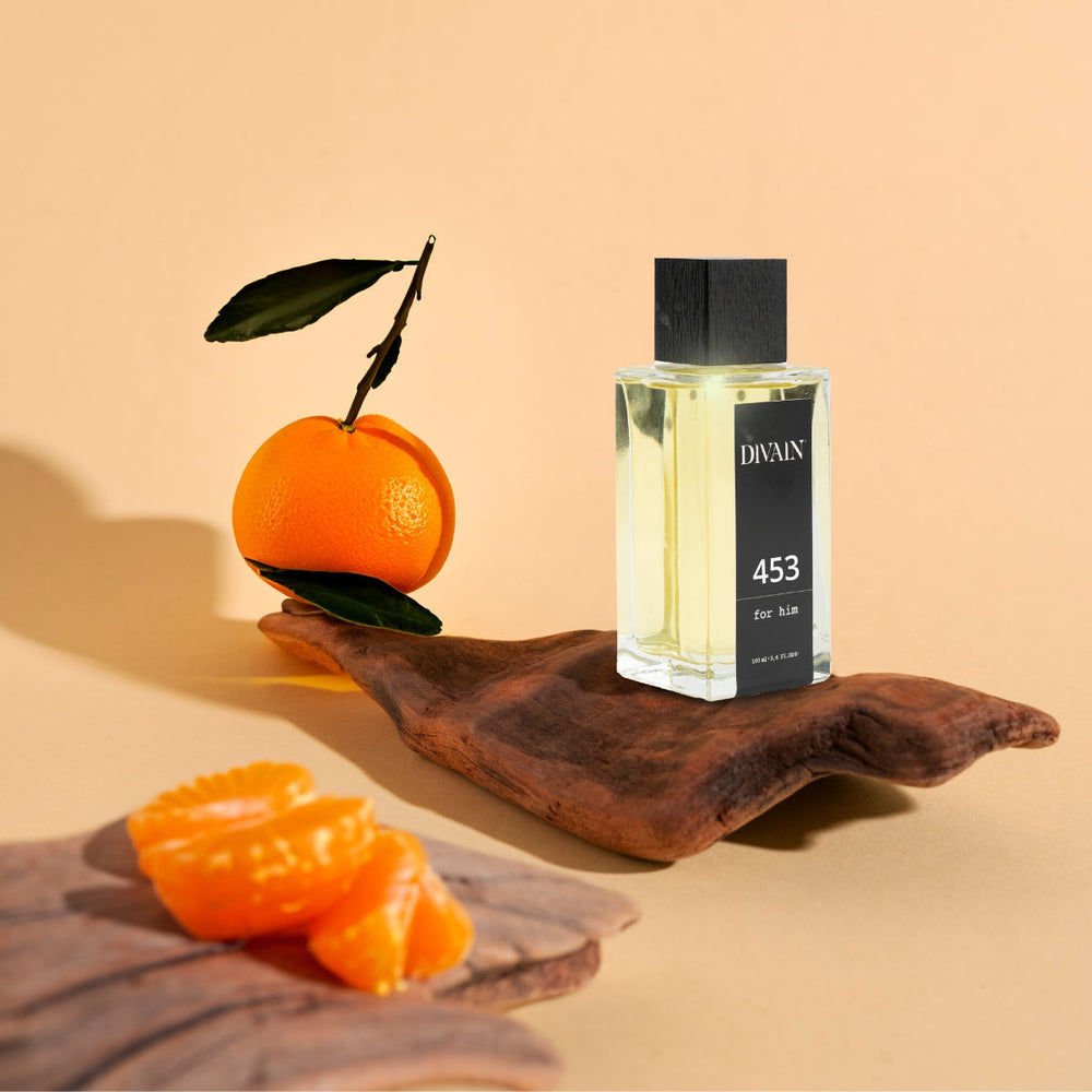 Perfume divain-453 surrounded by its olfactory notes like orange