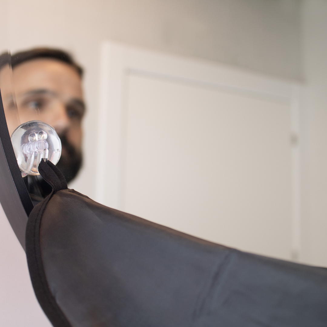 Shaving cap with suction cups on the mirror