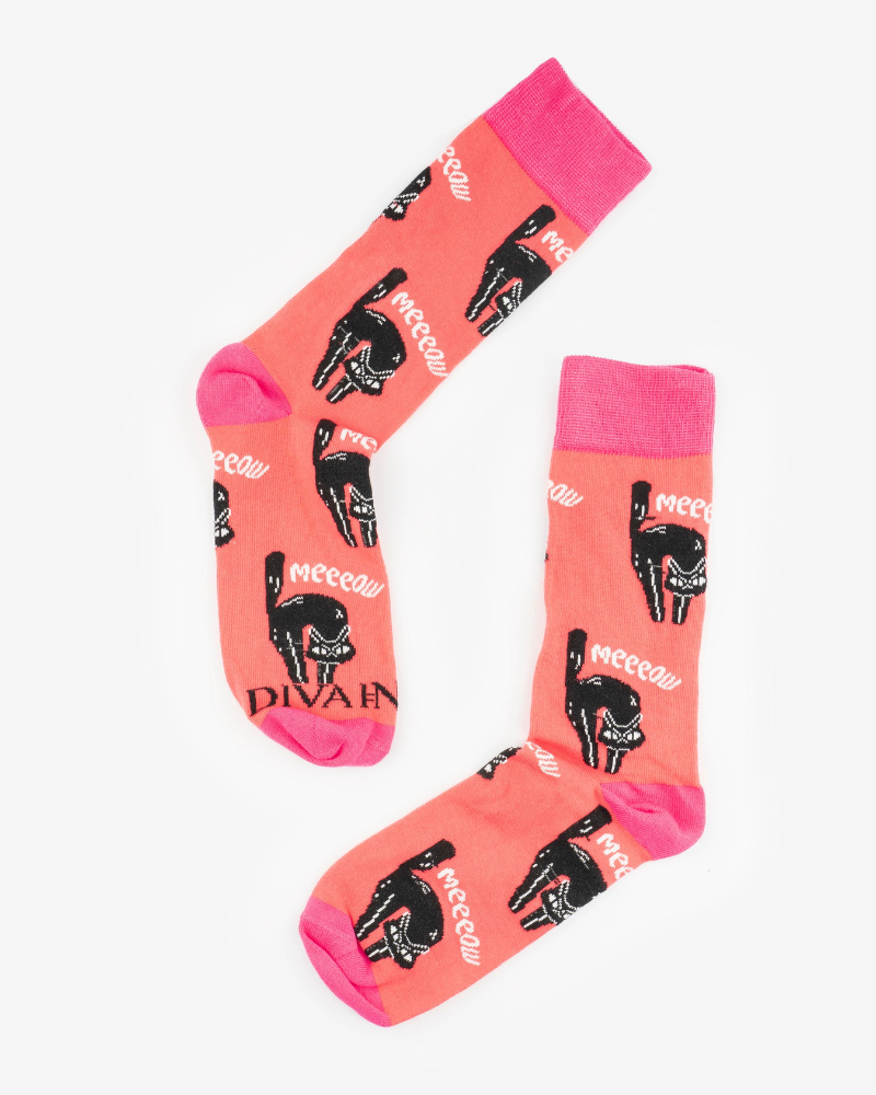 Orange and pink socks with black cats and the word meeeow stitched on them as well.